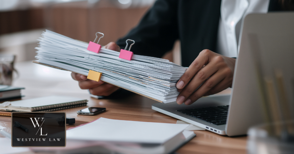 Employee gathering documents and evidence before meeting a workplace harassment lawyer