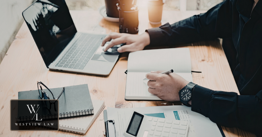 Employee writing down workplace discrimination incidents in notebook