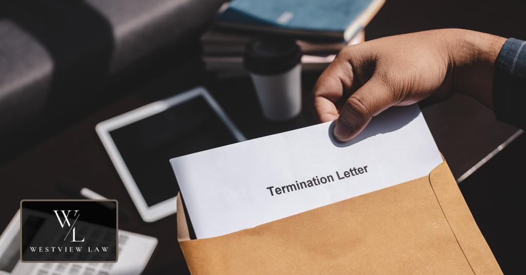 Employee holding a termination letter in an envelope, illustrating potential wrongful termination after FMLA leave.