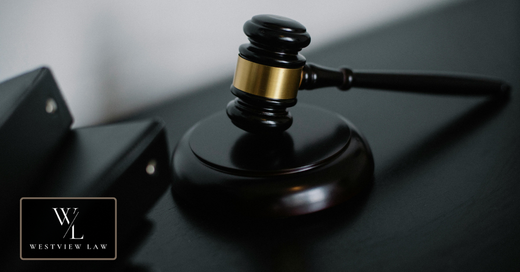 Judge’s gavel resting on a dark desk beside legal folders, representing legal remedies for wrongful termination after FMLA leave.