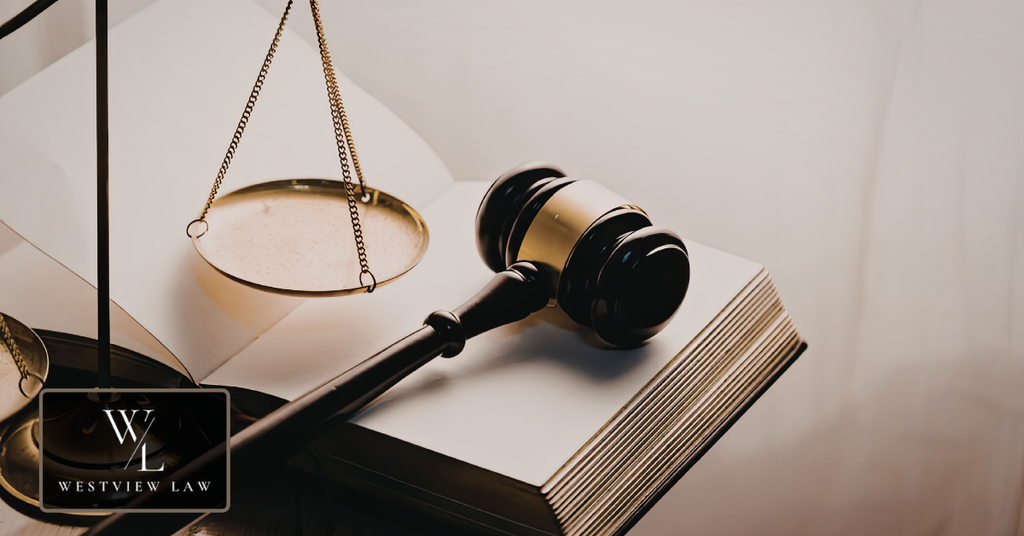 Judge's gavel resting on an open law book beside golden scales of justice, representing California employment law and employee workplace rights.