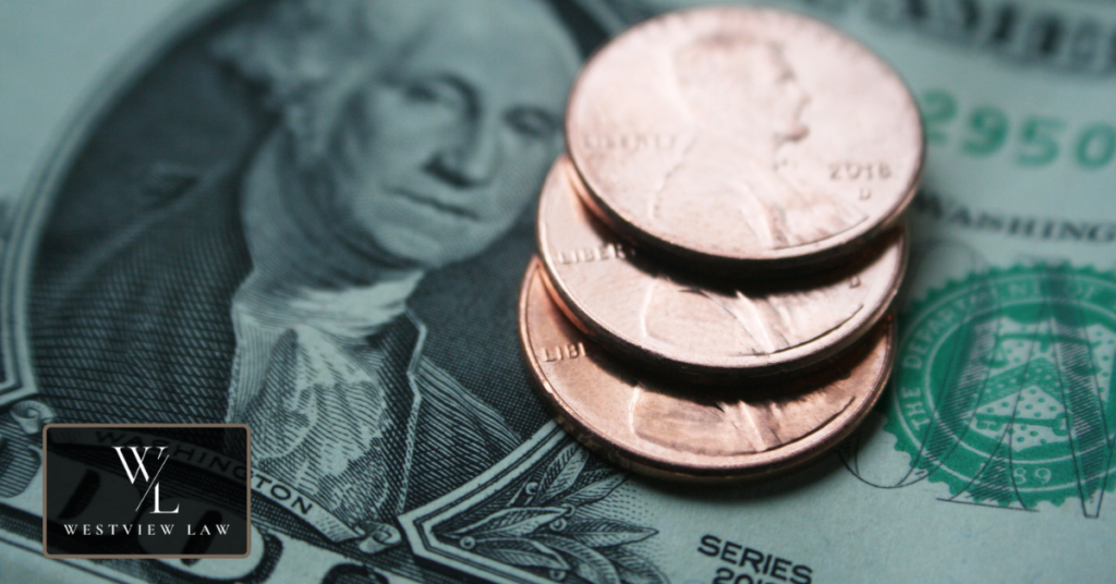 Recovering Stolen Wages in California Three pennies stacked on a US dollar bill, representing the pay California workers lose to wage theft