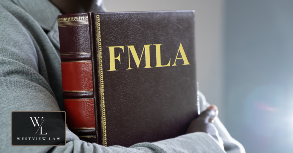 Compensation in an FMLA Case Person holding an FMLA law book, representing compensation you can recover in an FMLA wrongful termination case