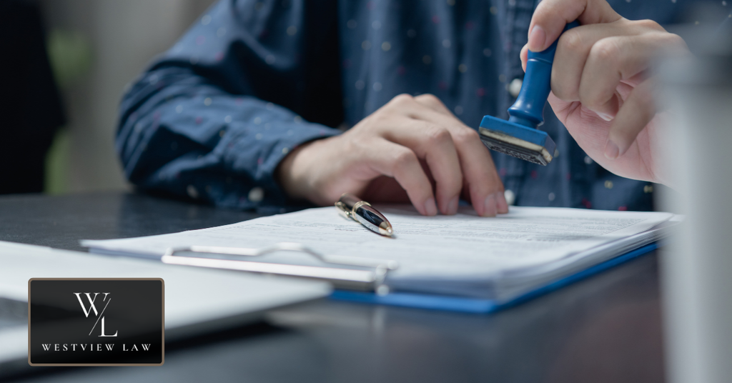 Person processing paperwork representing medical certification and documentation for an FMLA leave request.
