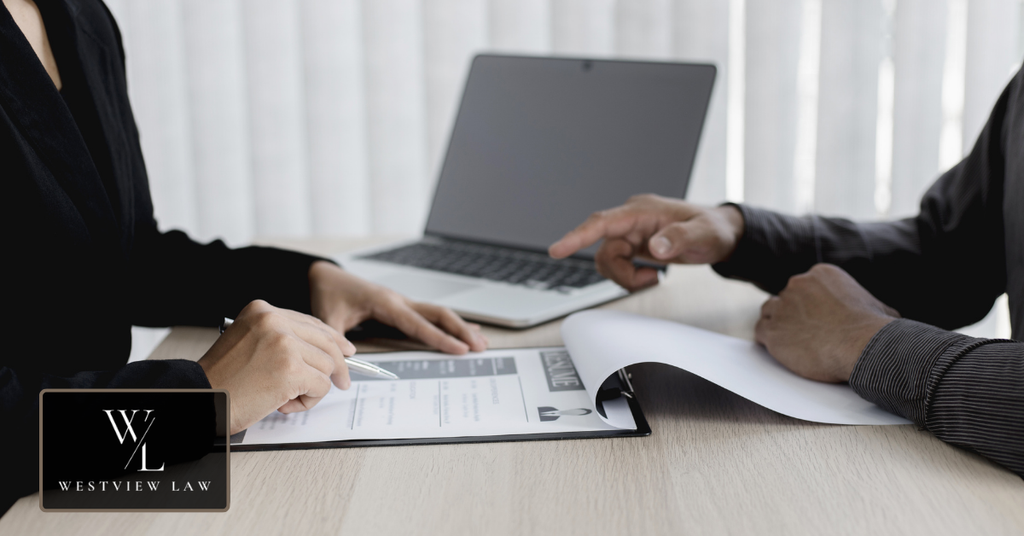 Employees reviewing workplace documents and records that may be used as evidence in a retaliation claim.