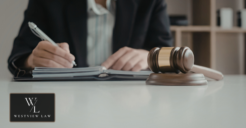 Employment lawyer preparing legal documents beside a judge’s gavel for an FMLA violation case.
