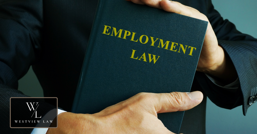 Attorney holding an employment law book representing employee legal rights in California.