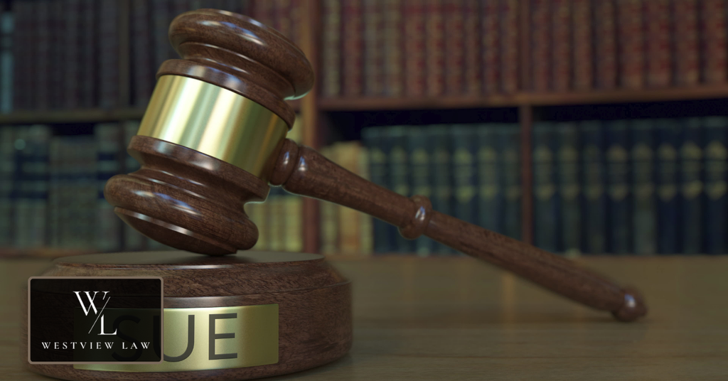 Judge’s gavel and law books representing legal action against an employer for false promises.