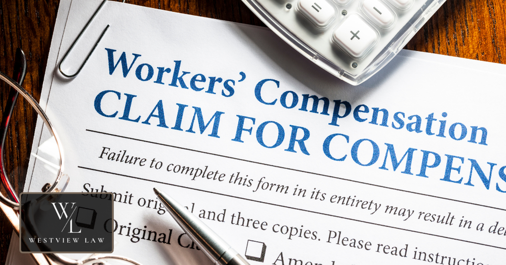 Workers’ compensation claim form with a calculator and pen representing benefits available after a workplace injury.