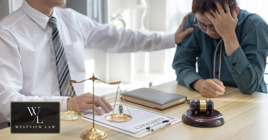 Stressed employee consulting an employment attorney about a workplace dispute, with legal documents, scales of justice, and a gavel on the desk.